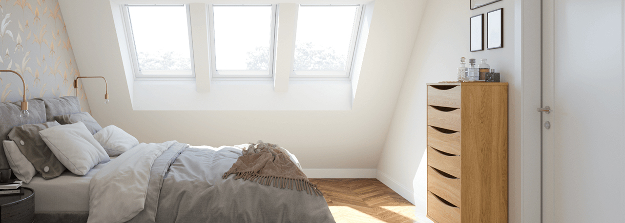 Drei VELUX Dachfenster erhellen ein stilvolles Schlafzimmer im Dachgeschoss