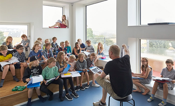 Children in classroom with lots of daylight - VELUX Commercial