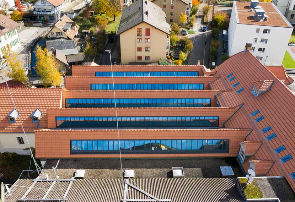 Tageslicht-Lösung mit VELUX Modular Skylights als Sheddach-Lichtband 25°–90° / Bucher Areal, Burgdorf, Schweiz / Aussenansicht von Oben 