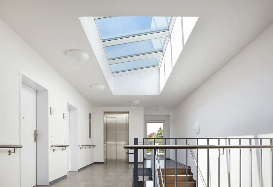 Skylights in social housing stairwell with VELUX Modular Skylights - Longlight 5-30°, Hamm, Germany